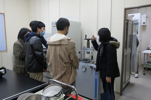 Graduate student explaining analytical devices